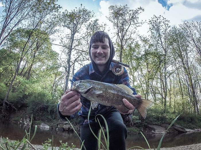 Diller holding a smallmouth and with better fishing gear